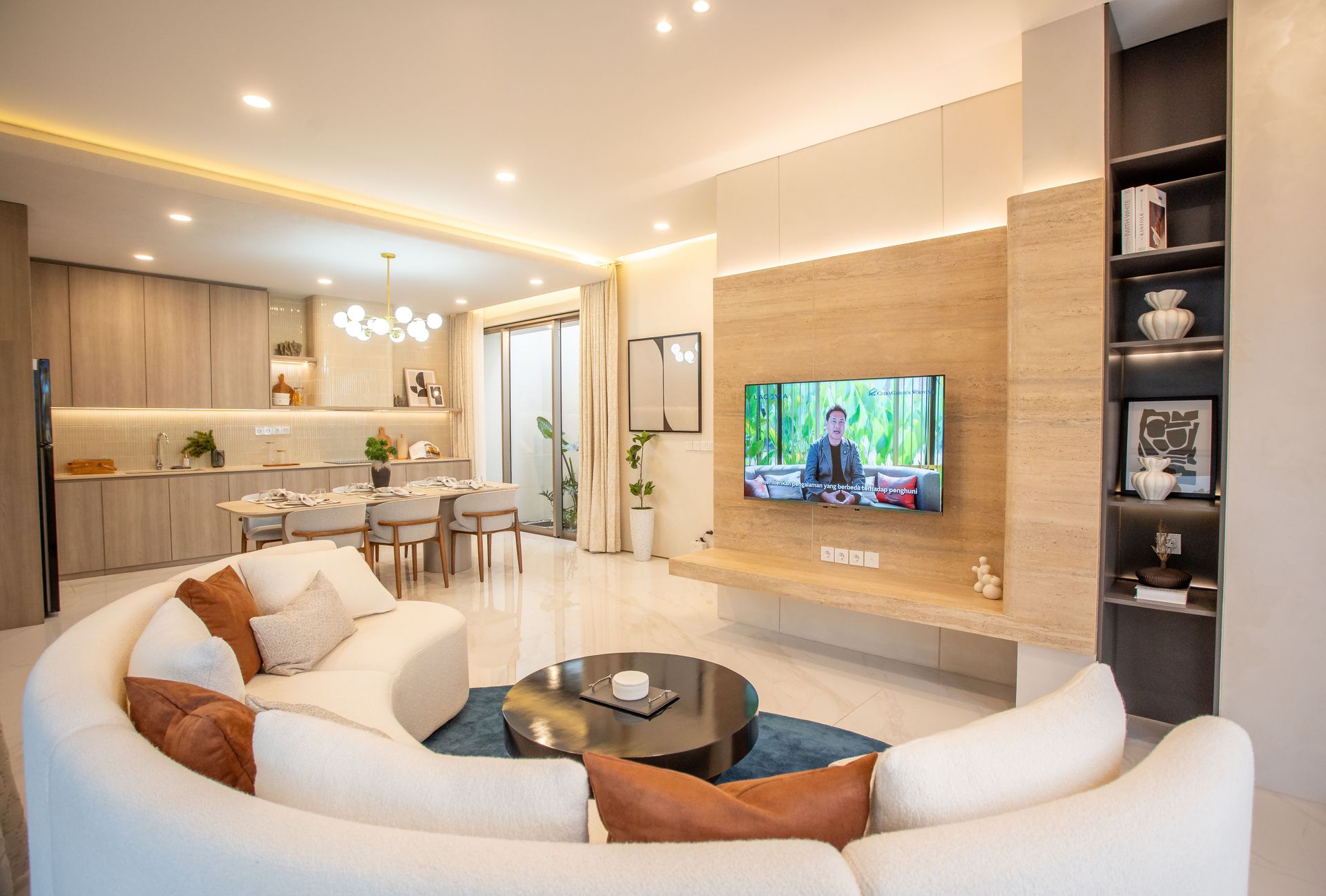 Elegant open plan living area with contemporary decor and kitchen space.